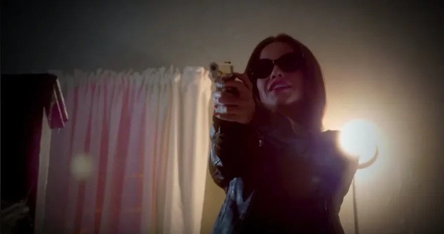 Jenna has a gun. &copy; Freeform